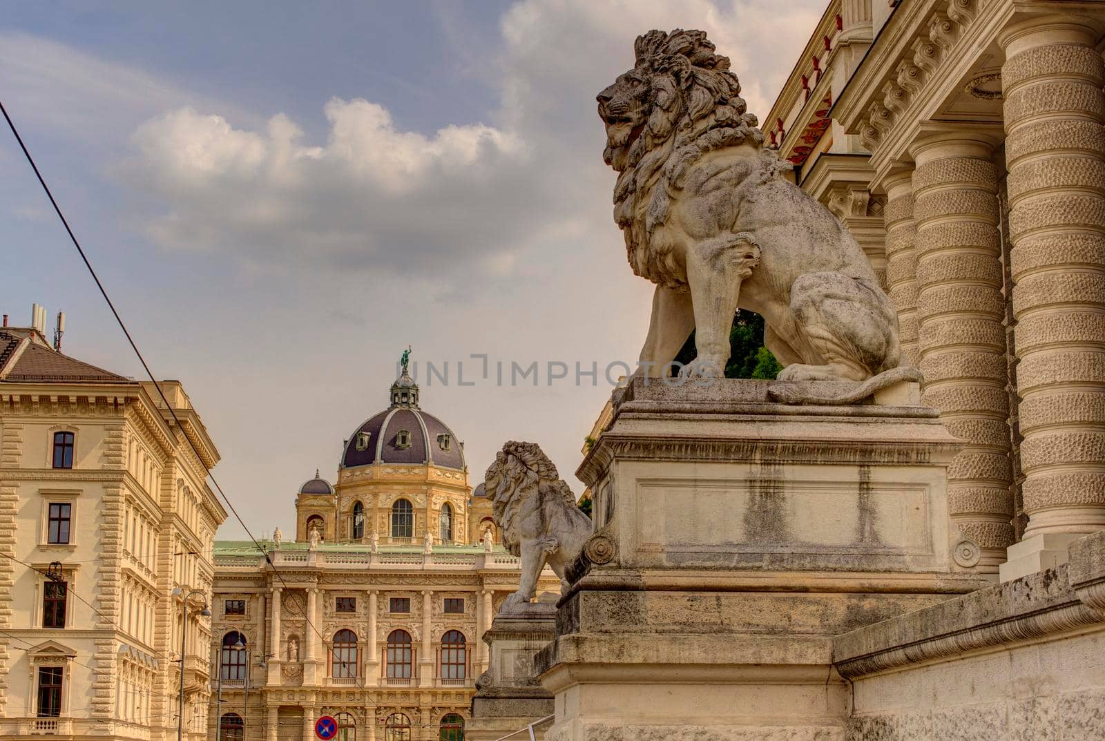 Lion statues in front of the Palace of Justice. In the background the Natural History Museum. Vienna