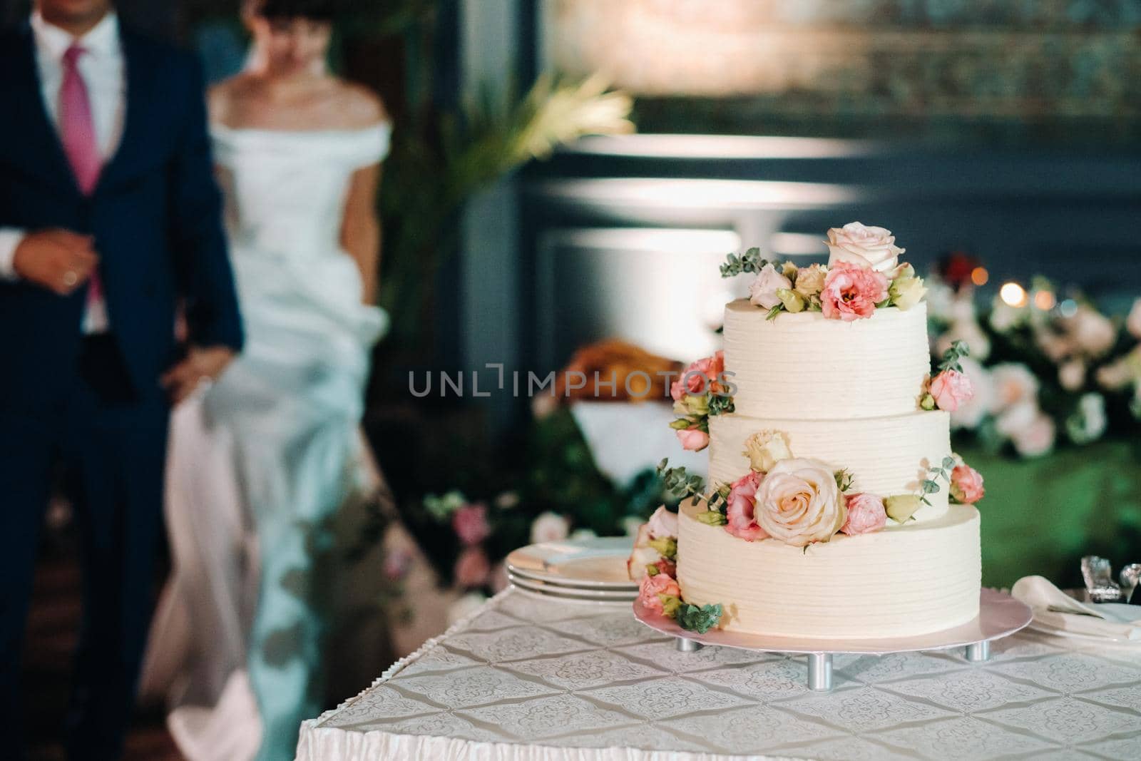 Elegant wedding cake at the wedding in three tiers.