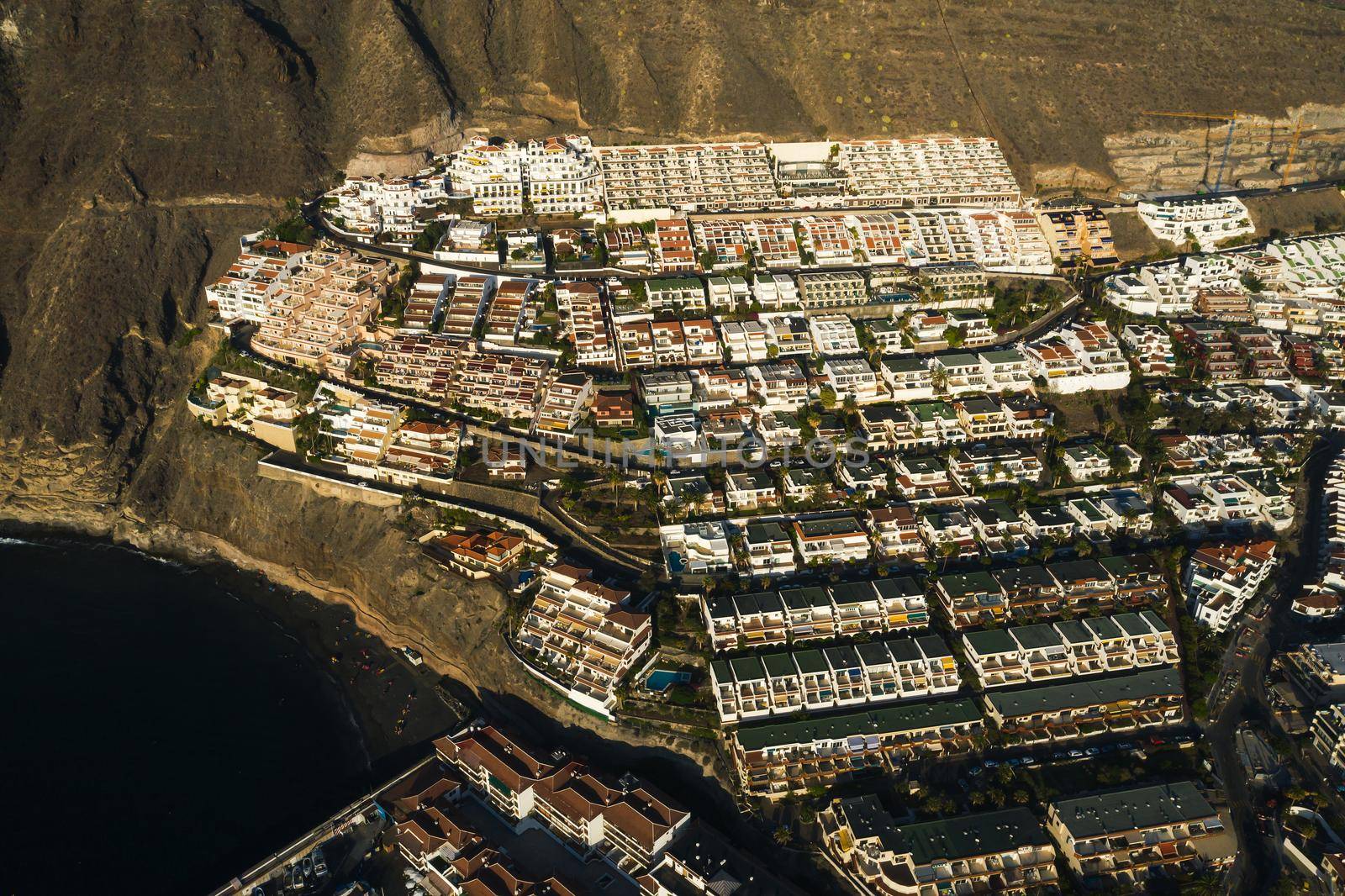 Aerial panorama of Acantilados de Los Gigantes Cliffs of the Giants at sunset, Tenerife, Canary islands, Spain. by Lobachad