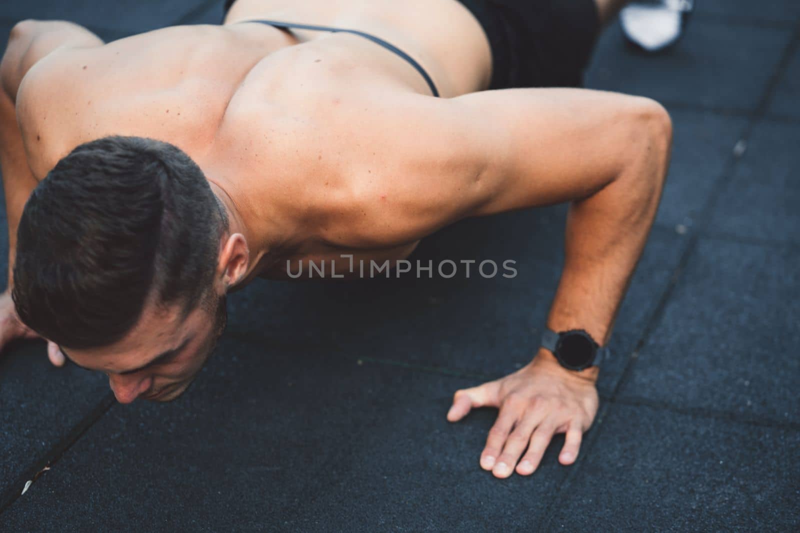 Fit man checking smart watch wearable technology sport smartwatch on workout outside. Man wearing smart watch during his training, measuring his activity. High quality photo