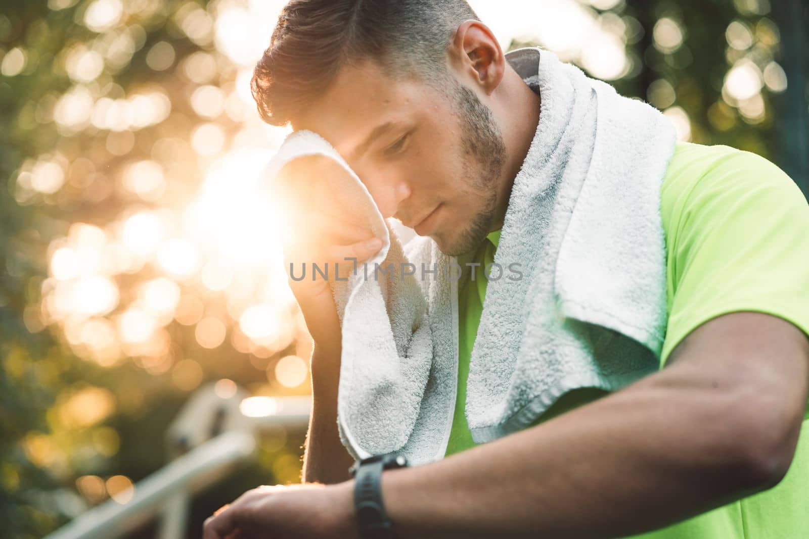 Fit man checking smart watch wearable technology sport smartwatch on workout outside. Man wearing smart watch during his training, measuring his activity. High quality photo