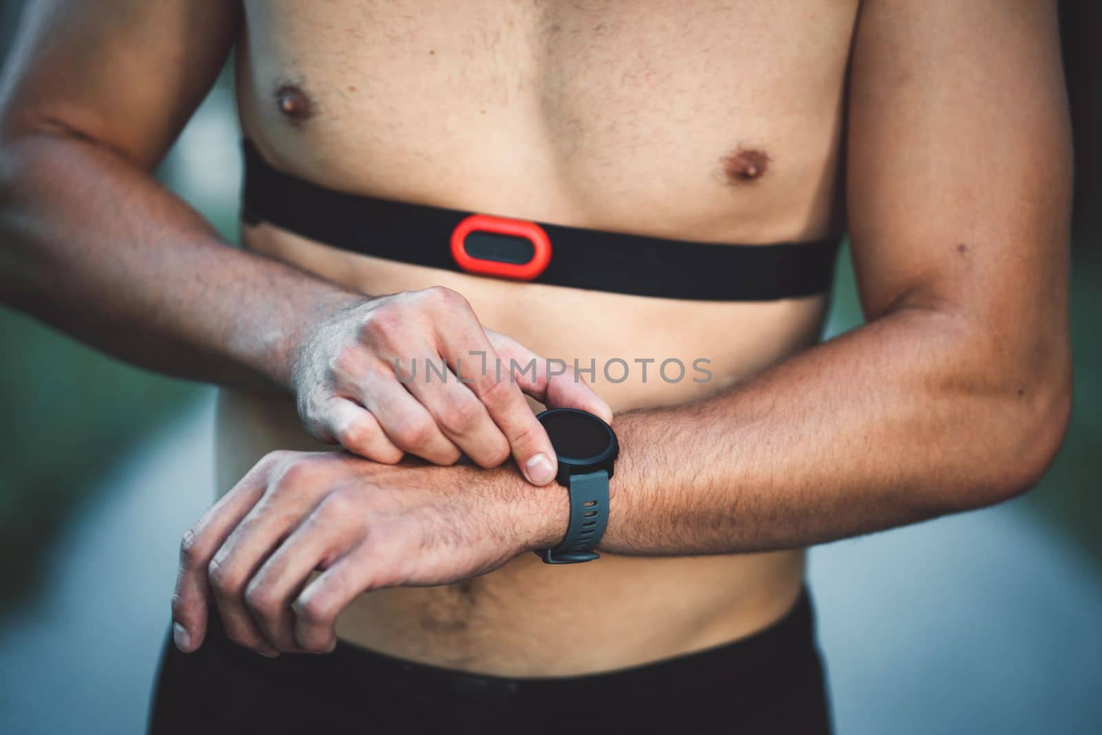 Fit man checking smart watch wearable technology sport smartwatch on workout outside. Man wearing smart watch during his training, measuring his activity. High quality photo