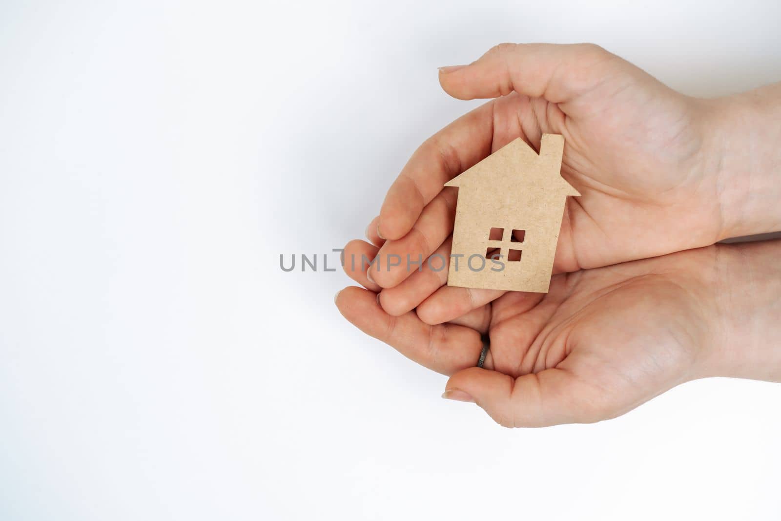 hands holding paper house, family home, homeless housing, mortgage crisis and home protecting insurance concept, foster home care, family day care, social distancing