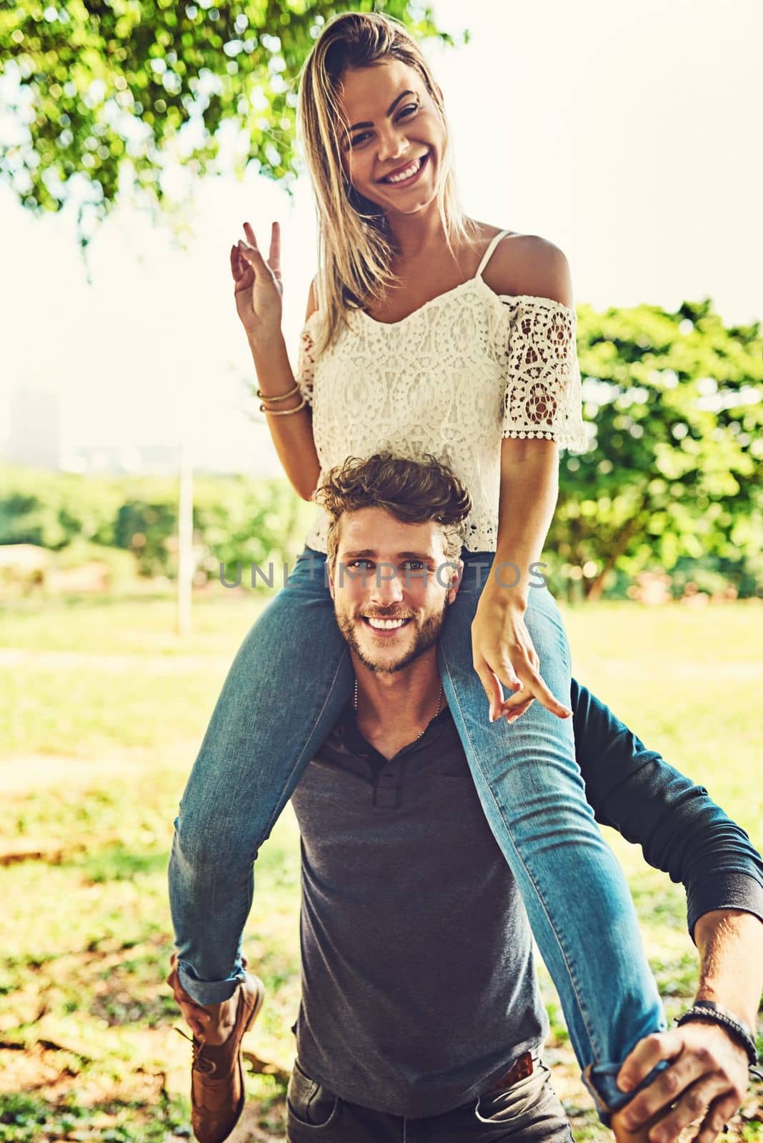 Loving their peaceful day together. Portrait of a young couple bonding together outdoors. by YuriArcurs