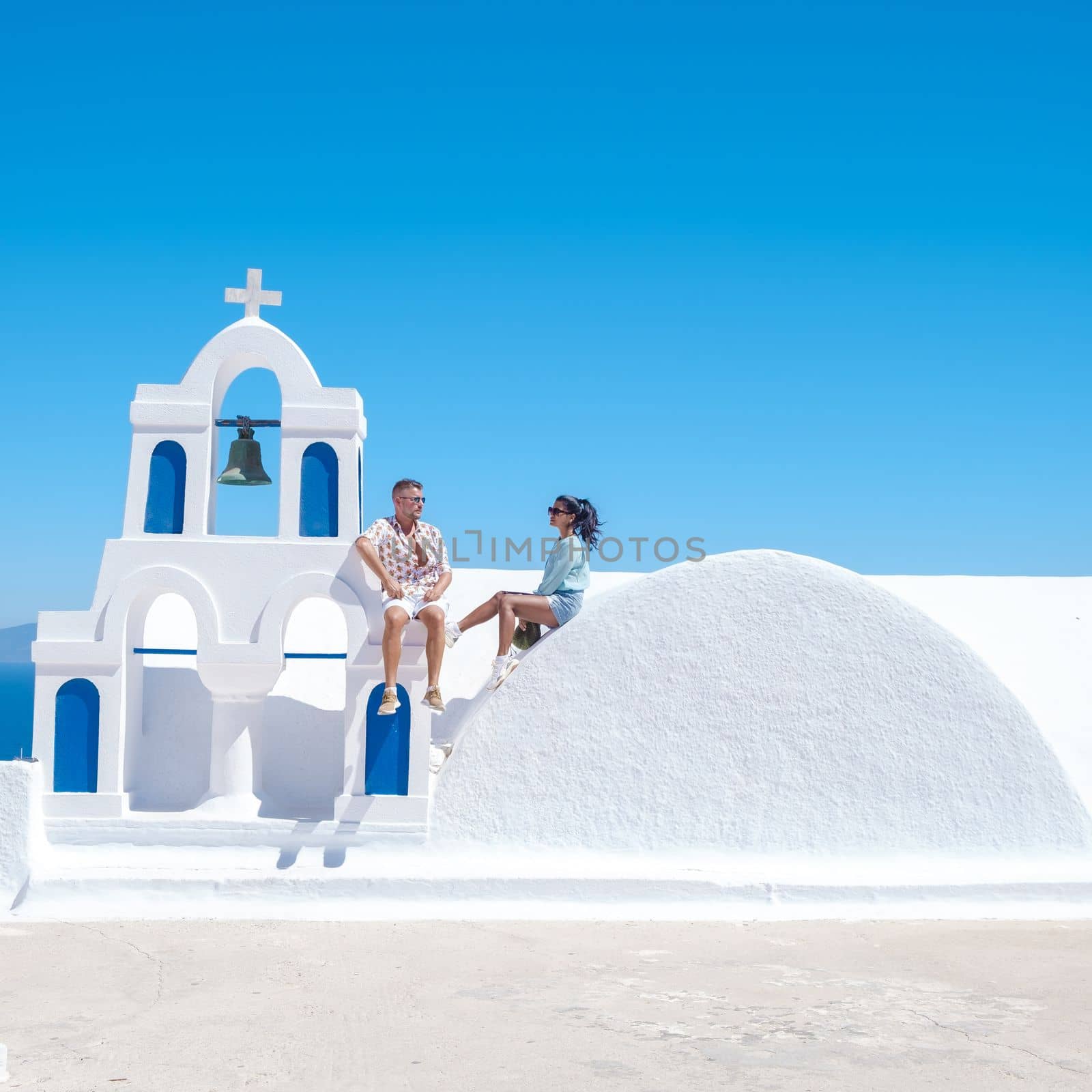 couple of men and women on vacation in Santorini Greece. young couple on vacation in Greece Santorini