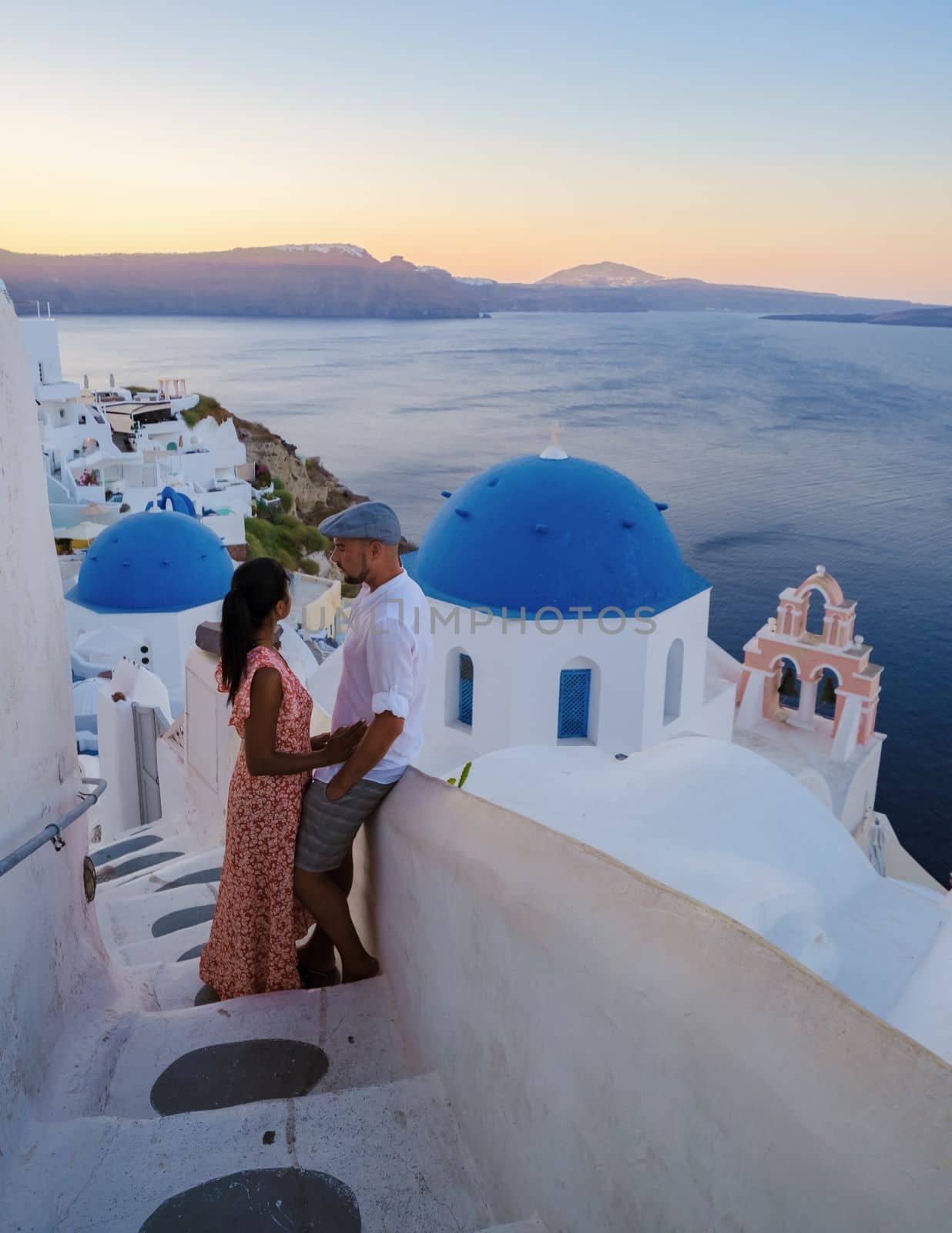 Couple on vacation in Santorini Greece during summer at a Greek village by fokkebok