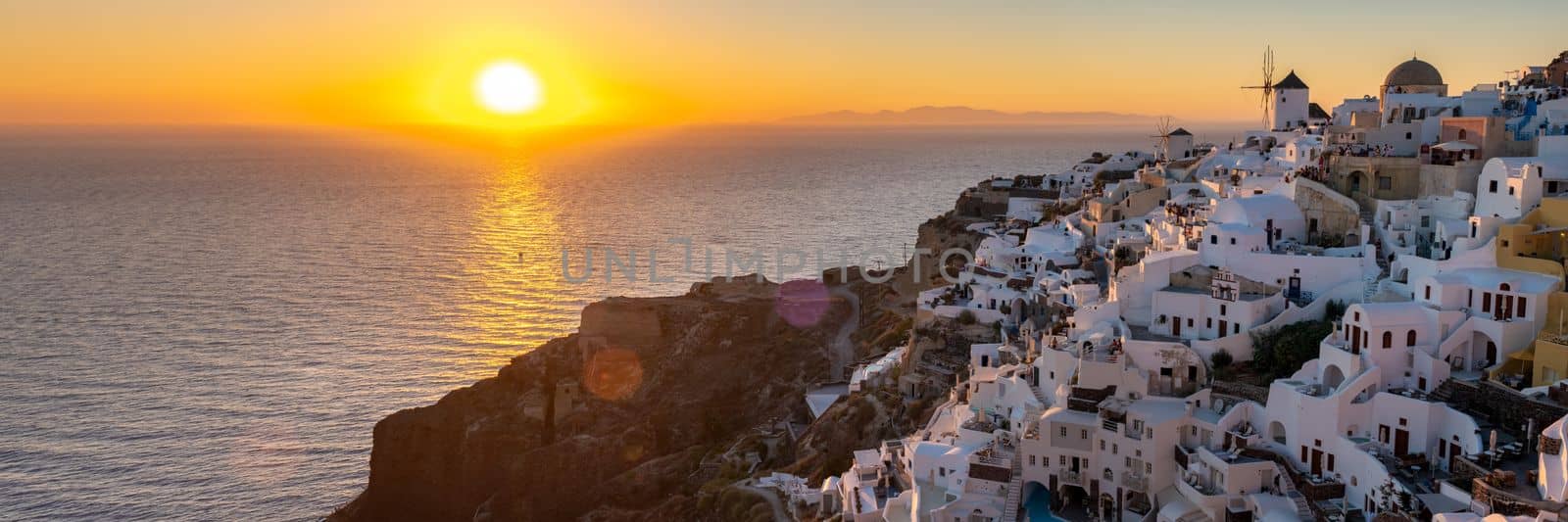 White churches an blue domes by the ocean of Oia Santorini Greece, traditional Greek village by fokkebok