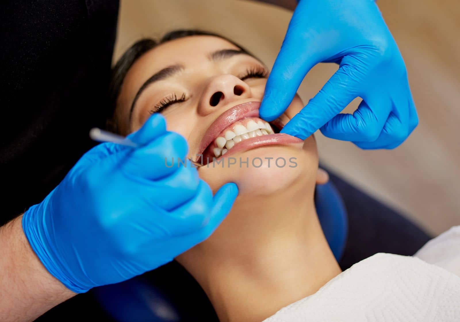 Get the smile you deserve. a young woman having a dental procedure performed on her. by YuriArcurs