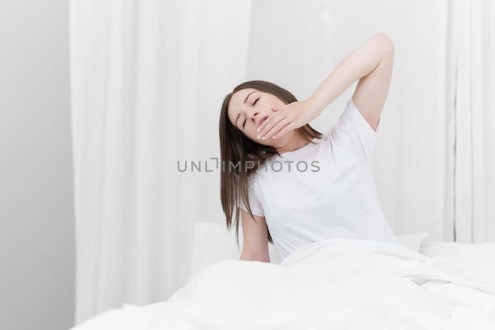 Image of beautiful young woman resting in bed at bedroom. Lifestyle at home concept by itchaznong