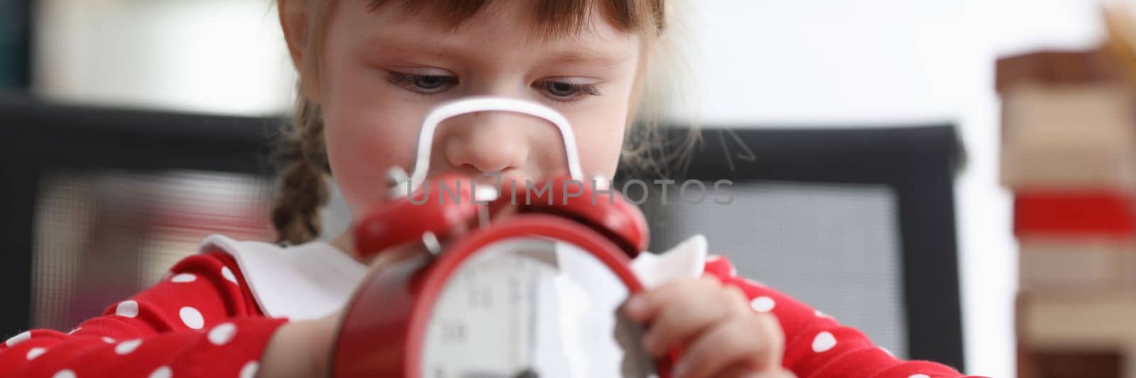 Cute little girl with red alarm clock by kuprevich