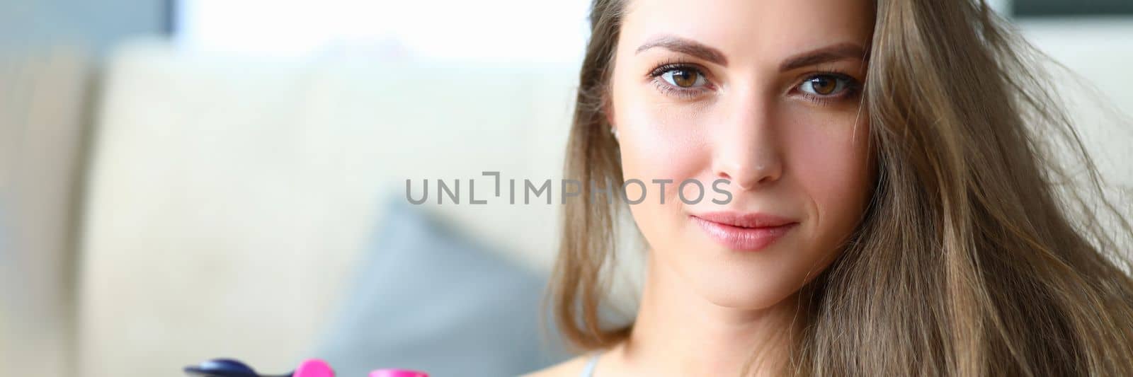 Portrait of beautiful strong happy young athletic woman with bottle of drinking water. Beauty health youth and sport
