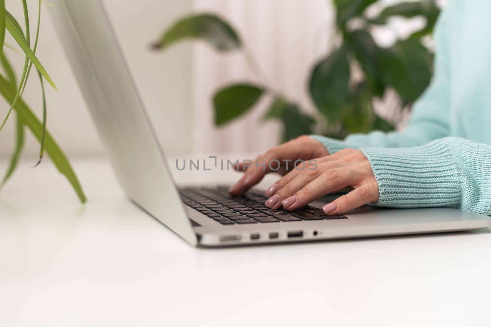 close-up of business woman hand typing and using laptop keyboard for searching with technology networking on working and job on desk at work place or work at home