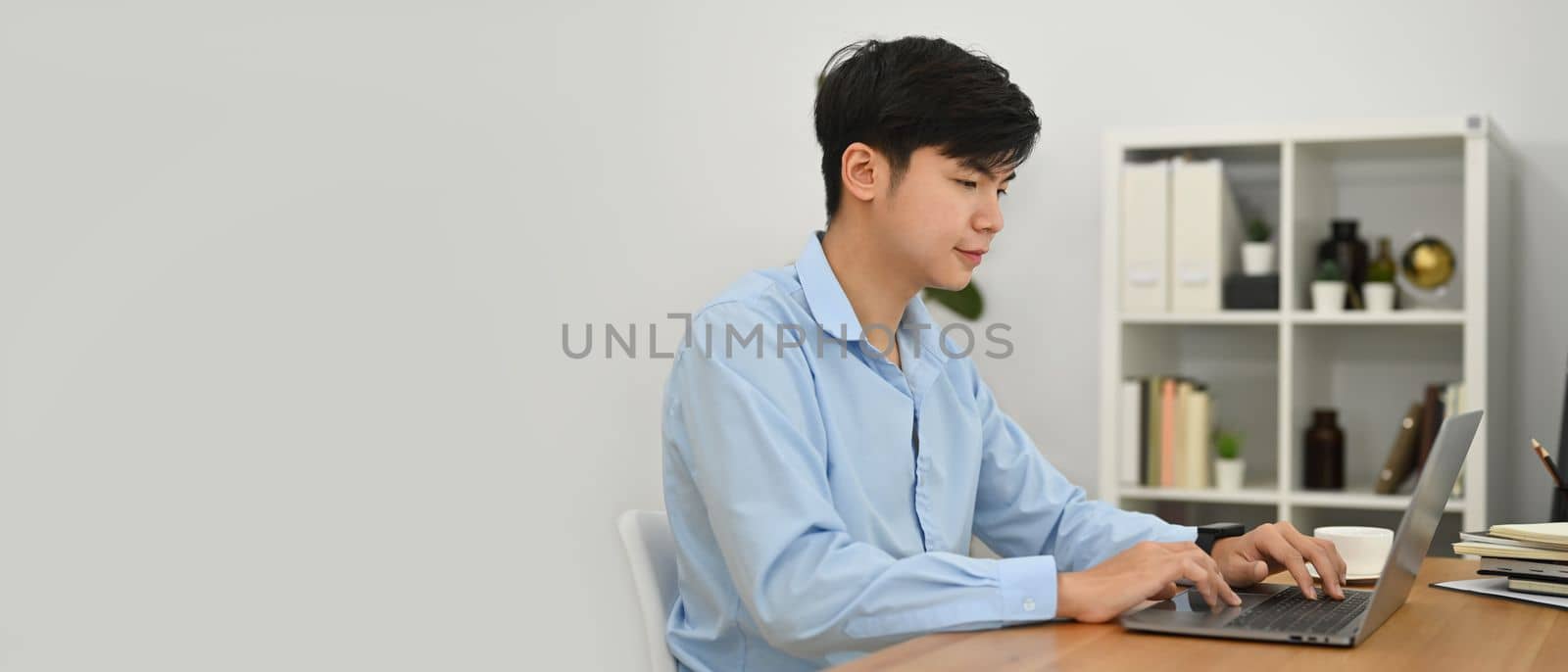 Businessman using laptop in the home office writing financial report, internet marketing, finance, business concept.