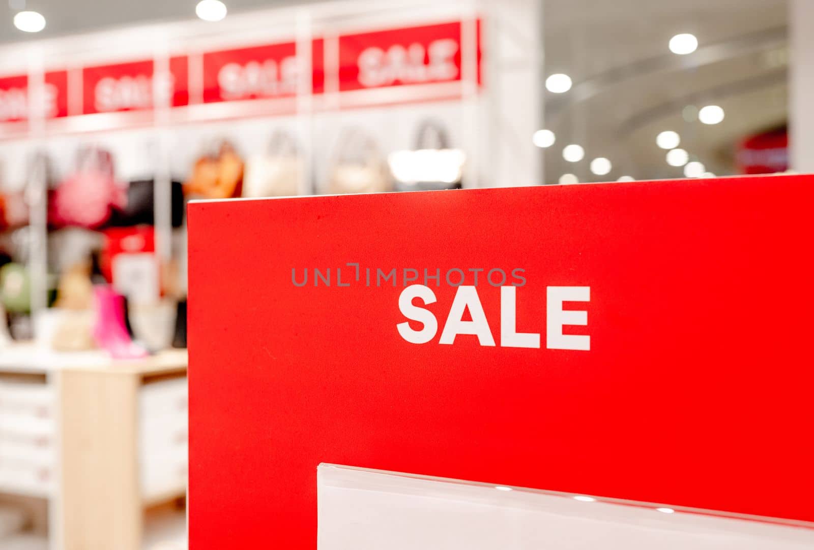 Sale season offers sign in commercial shopping center for better prices and discounts. Business marketing offer and promotions