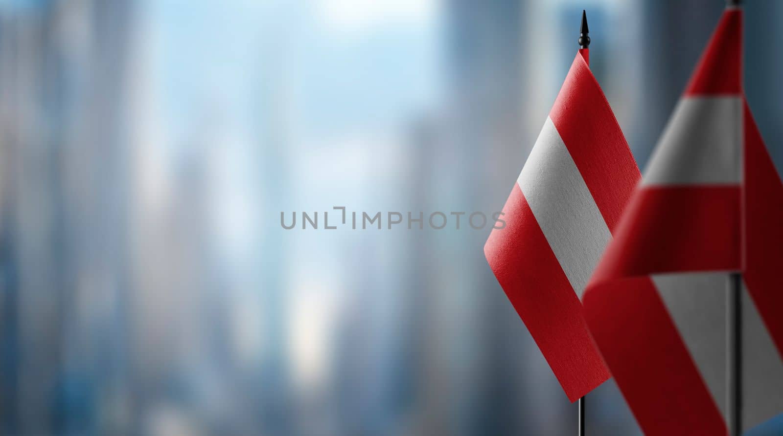 A small Austria flag on an abstract blurry background by butenkow