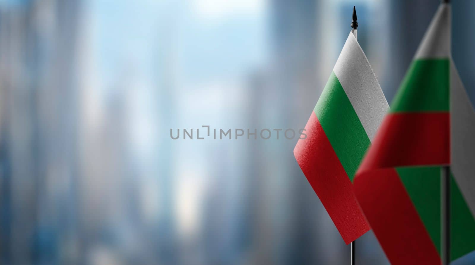 Small flags of the Bulgaria on an abstract blurry background by butenkow