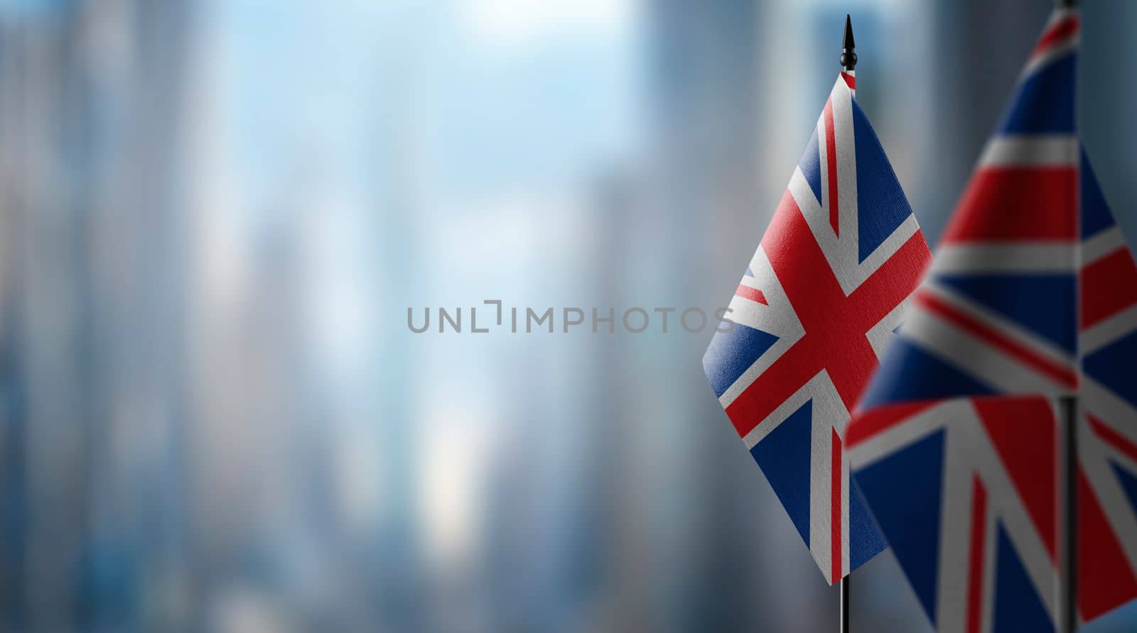 Small flags of the United Kingdom on an abstract blurry background by butenkow