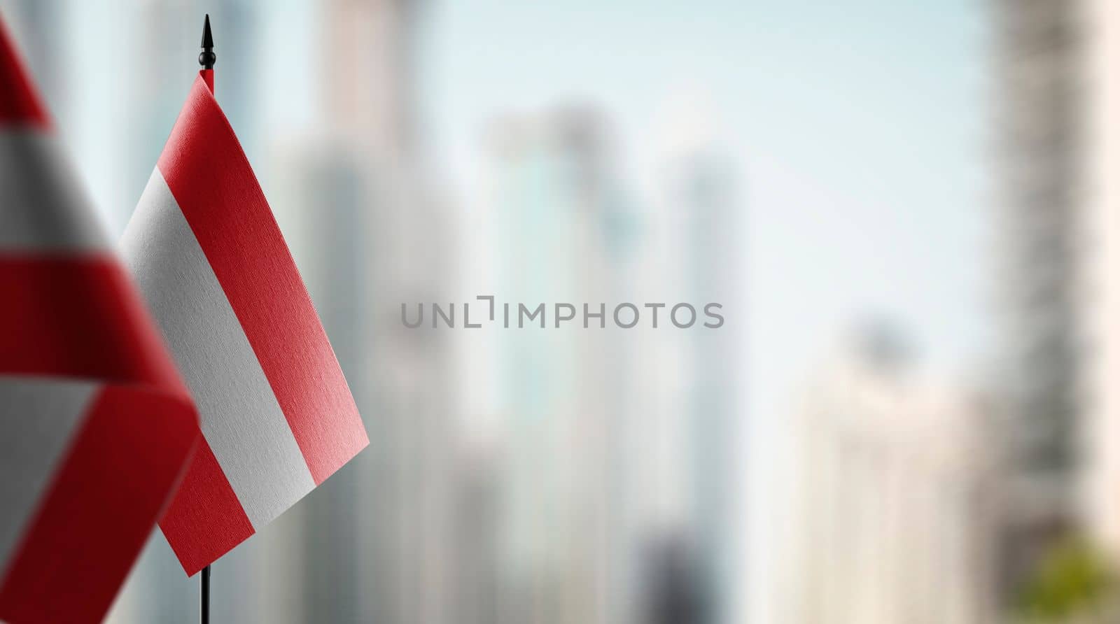 A small Austria flag on an abstract blurry background by butenkow