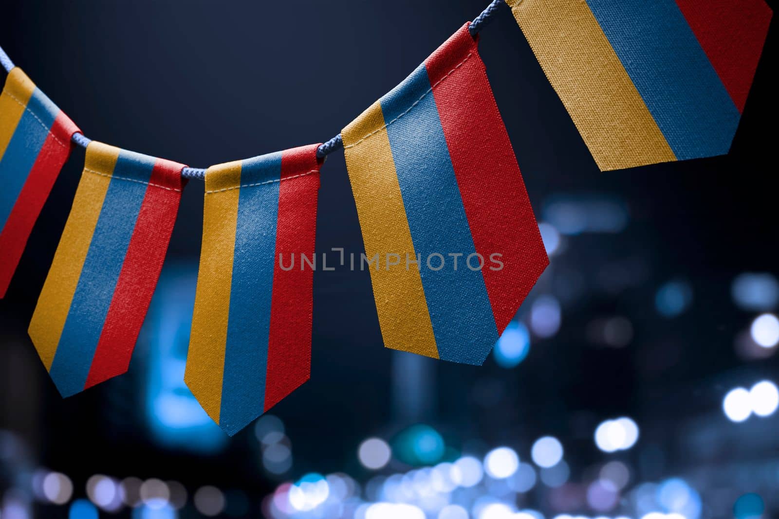 A garland of Armenia national flags on an abstract blurred background by butenkow