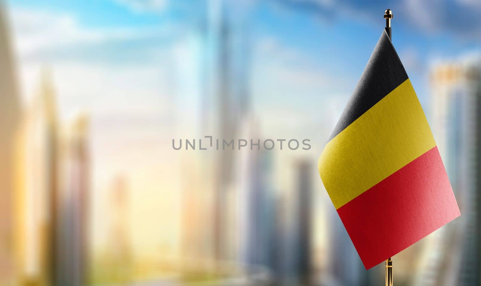 Small flags of the Belgium on an abstract blurry background by butenkow
