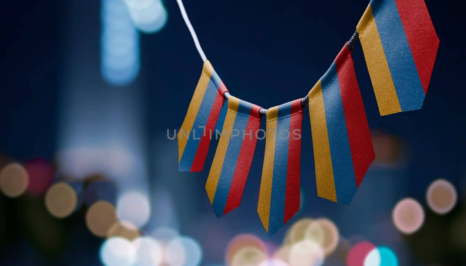 A garland of Armenia national flags on an abstract blurred background.