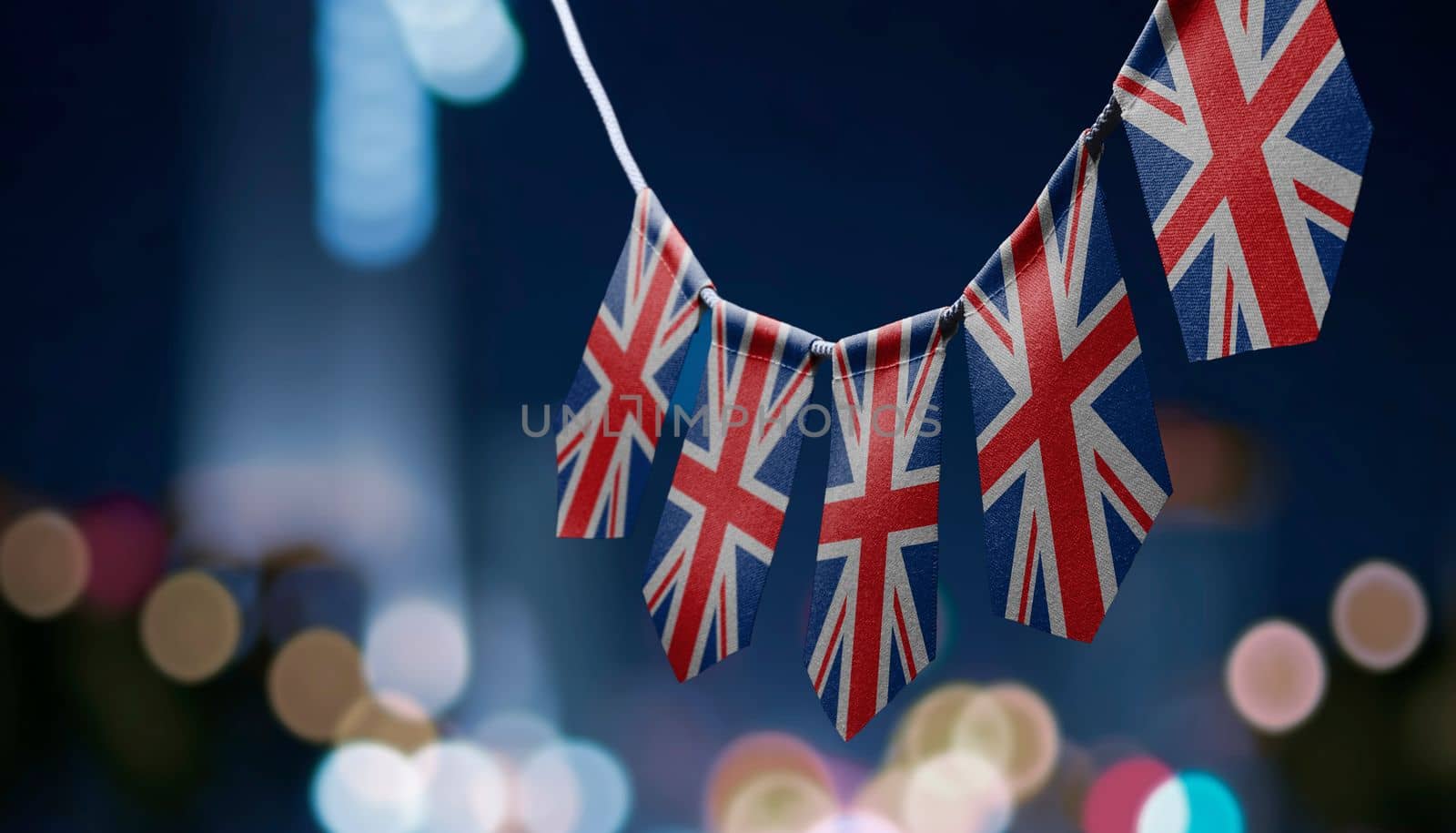 A garland of United Kingdom national flags on an abstract blurred background.