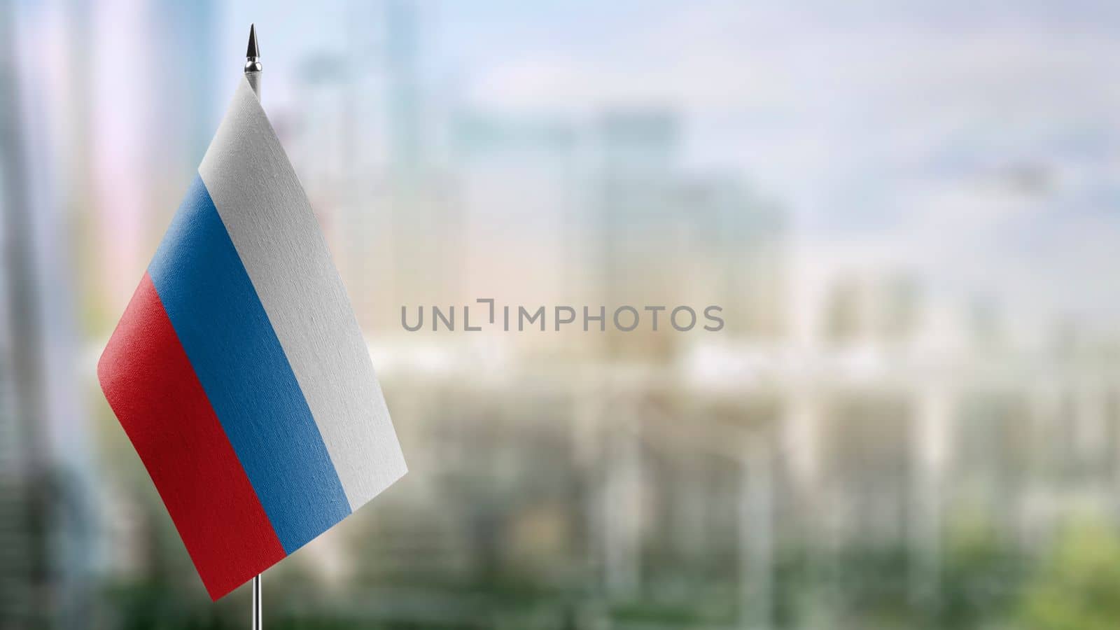 Small flags of the Russia on an abstract blurry background by butenkow