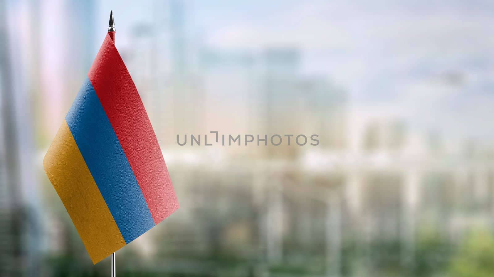 Small flags of the Armenia on an abstract blurry background.