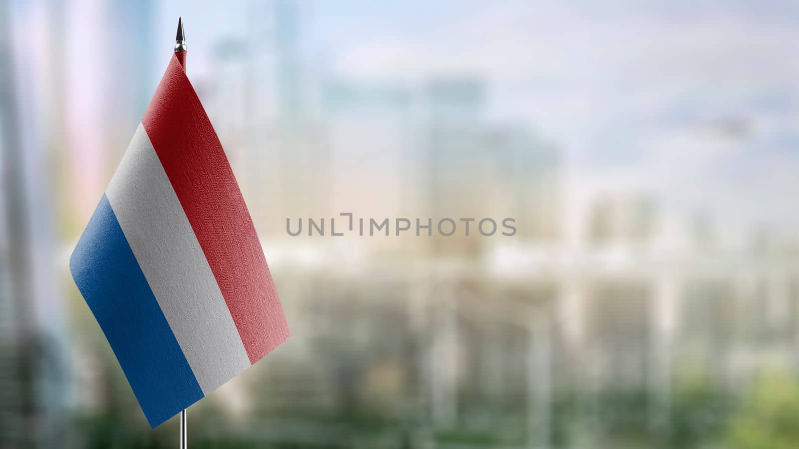 A small Netherlands flag on an abstract blurry background.