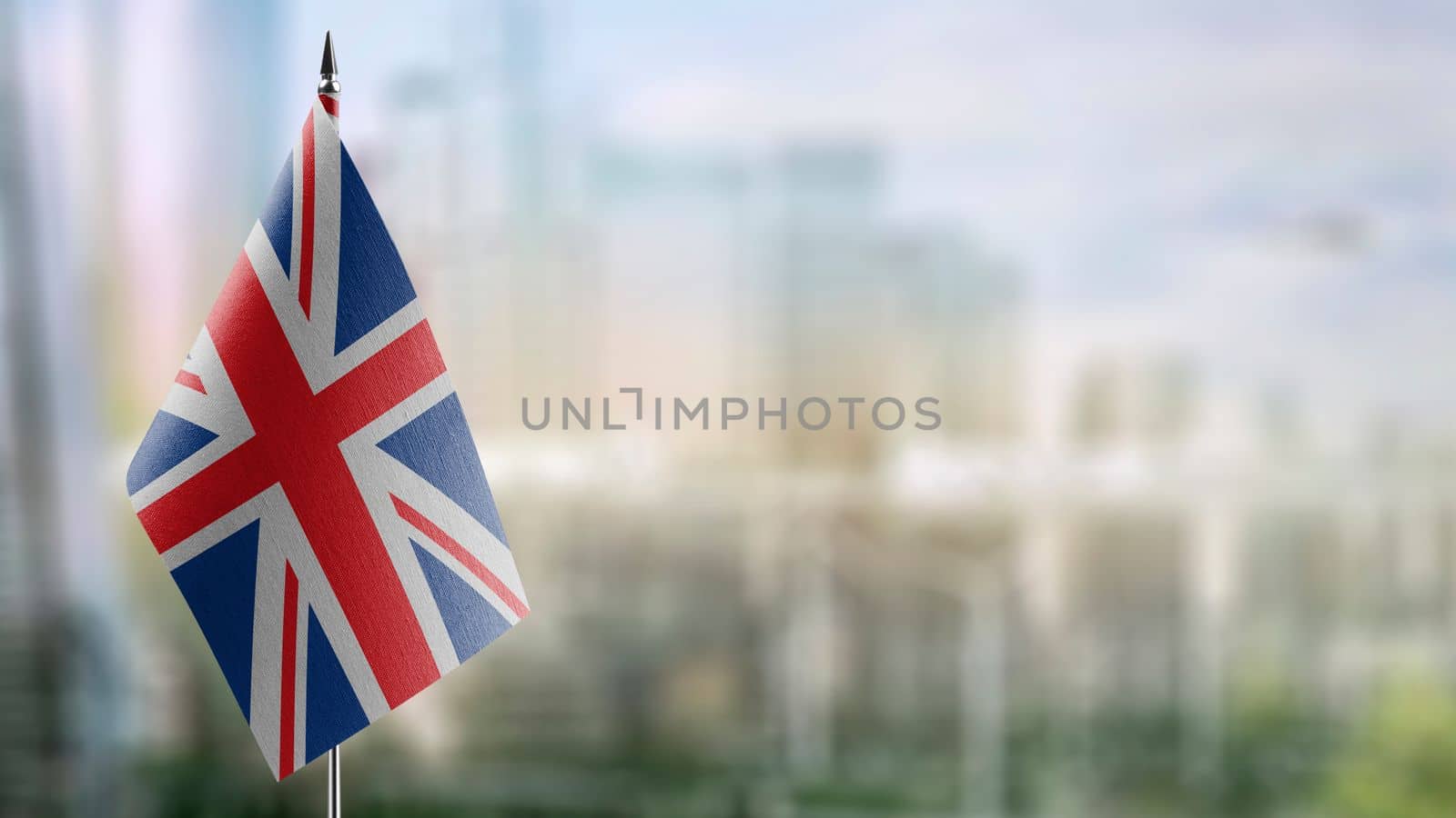 Small flags of the United Kingdom on an abstract blurry background by butenkow