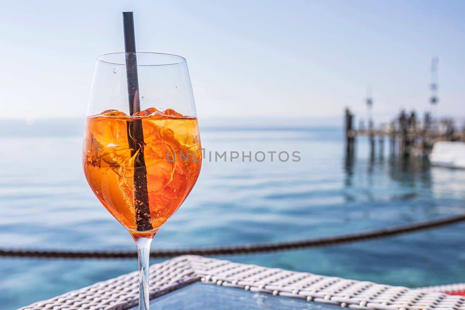 Cheers to good times: Elegant glassware on a seafront bar table by pippocarlot