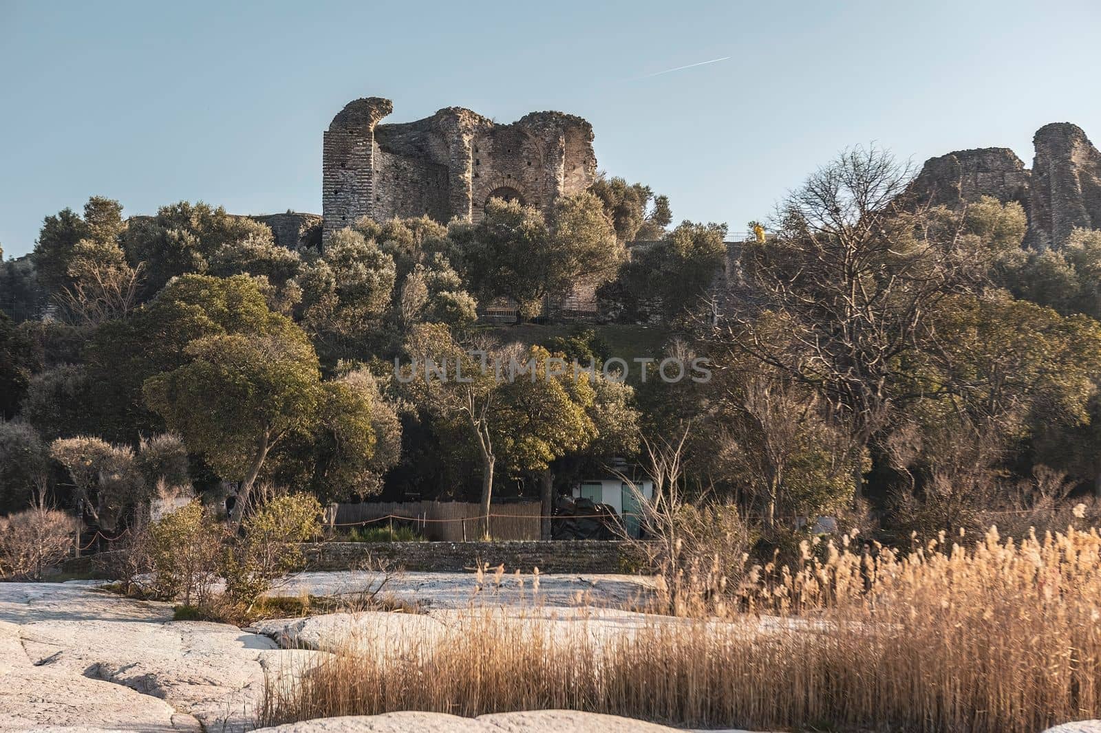 A breathtaking coastal view of ancient ruins in the charming town of Sirmione. This stunning photo captures the rich history and beauty of this iconic Italian destination.