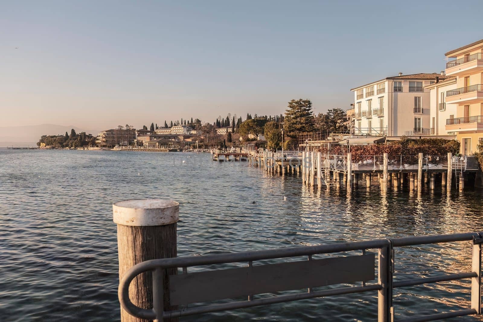 Capture the beauty of Sirmione's sunset with this stunning landscape photo. The vibrant colors and serene atmosphere make for a perfect wall art or background for any project