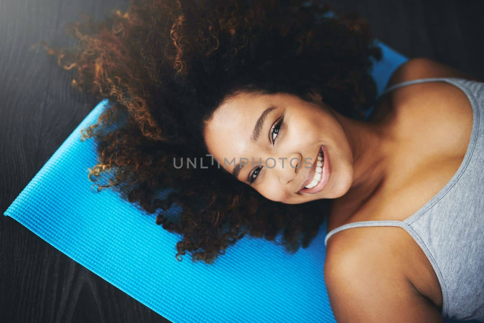 Yoga has a way of making you abundantly happy. High angle shot of a young woman practising yoga