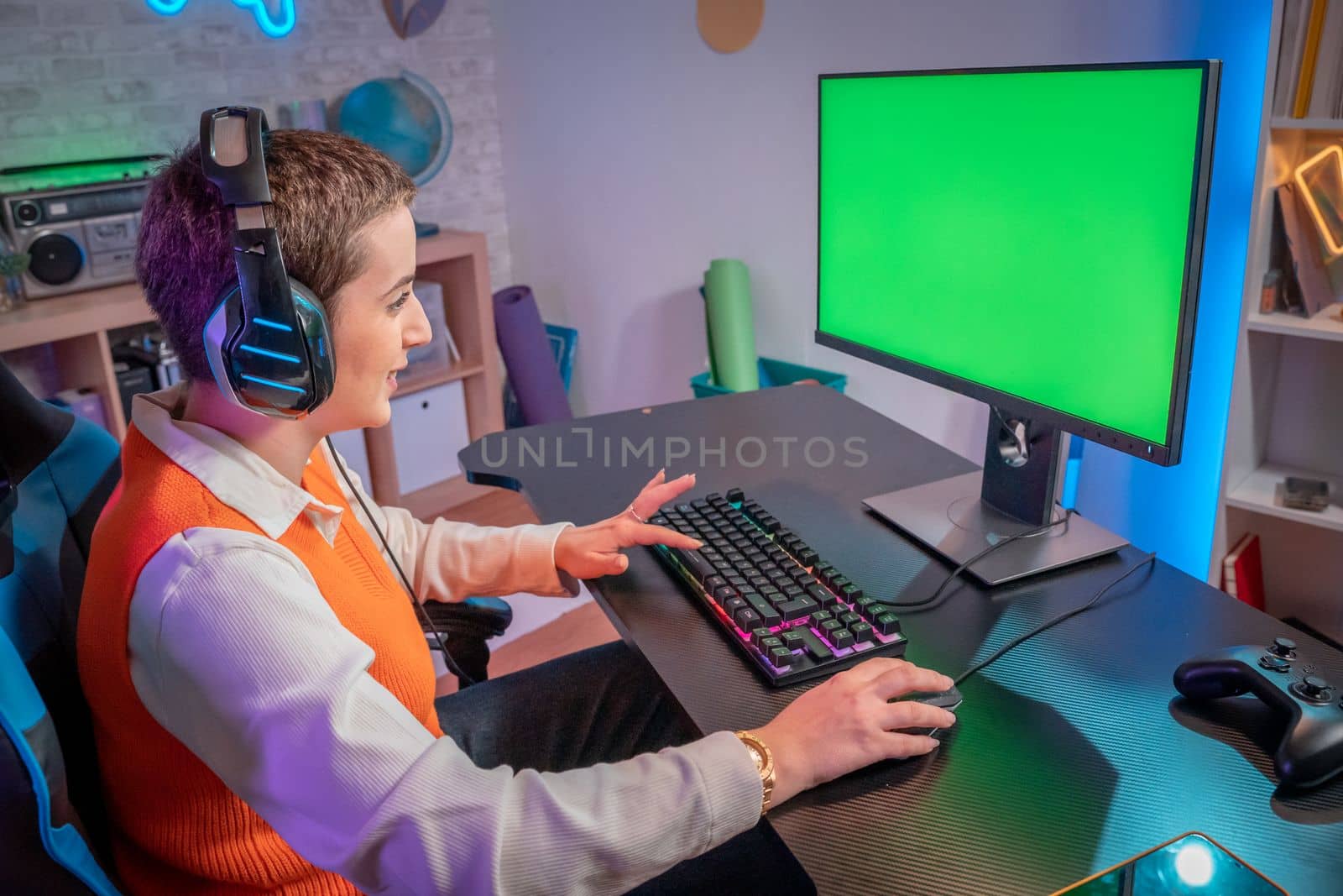 Pro gamer streaming video games with green screen mockup display in gaming neon lights home studio by PaulCarr
