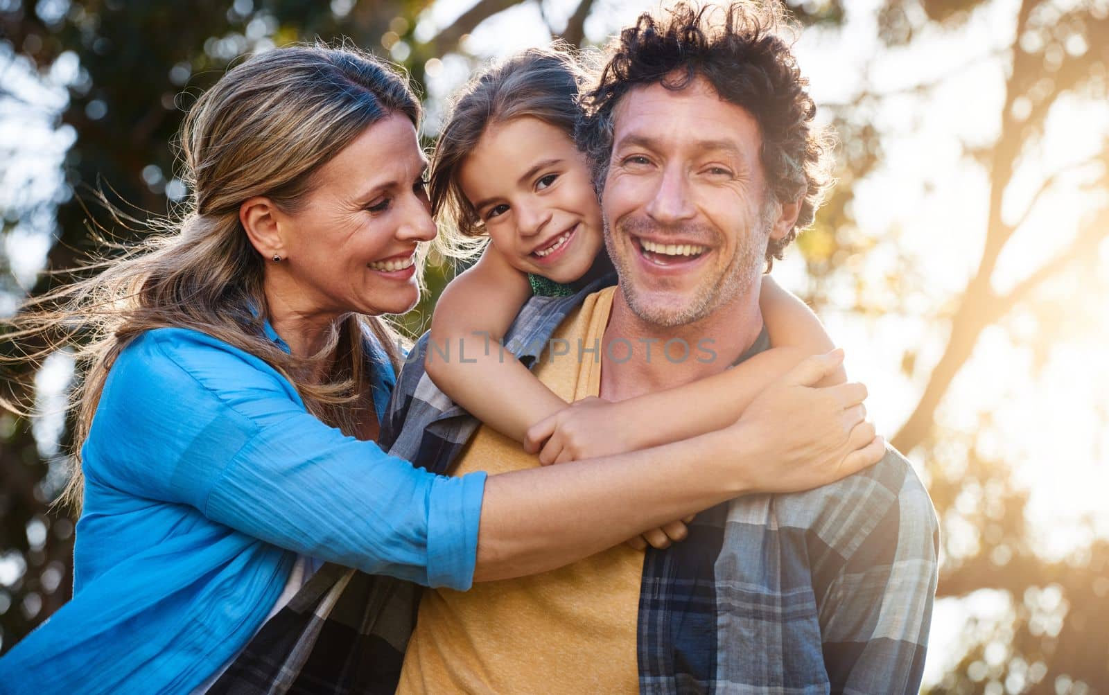 The value of family - priceless. Portrait of a happy family spending time together outdoors