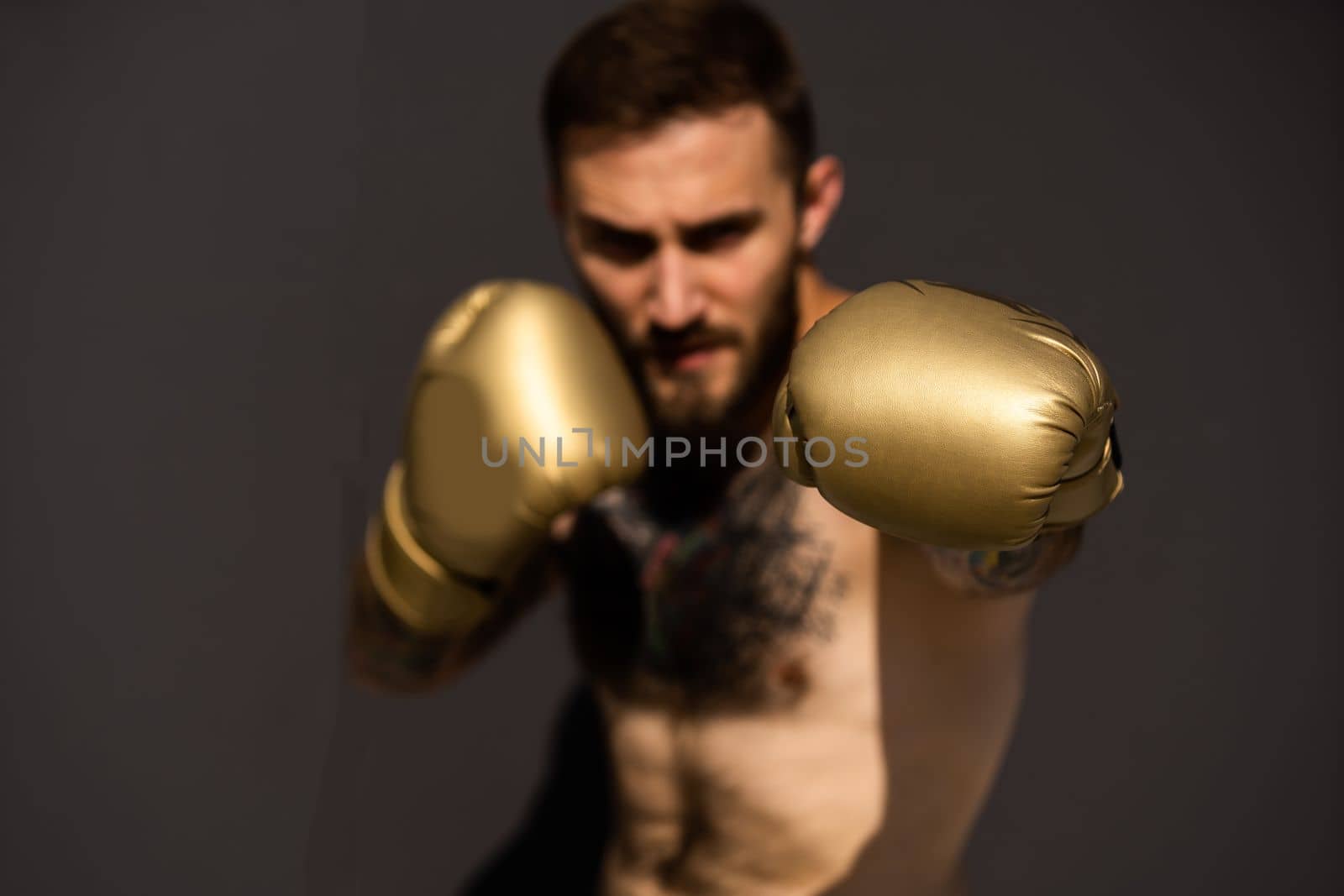a man trains in boxing gloves on the street by Andelov13