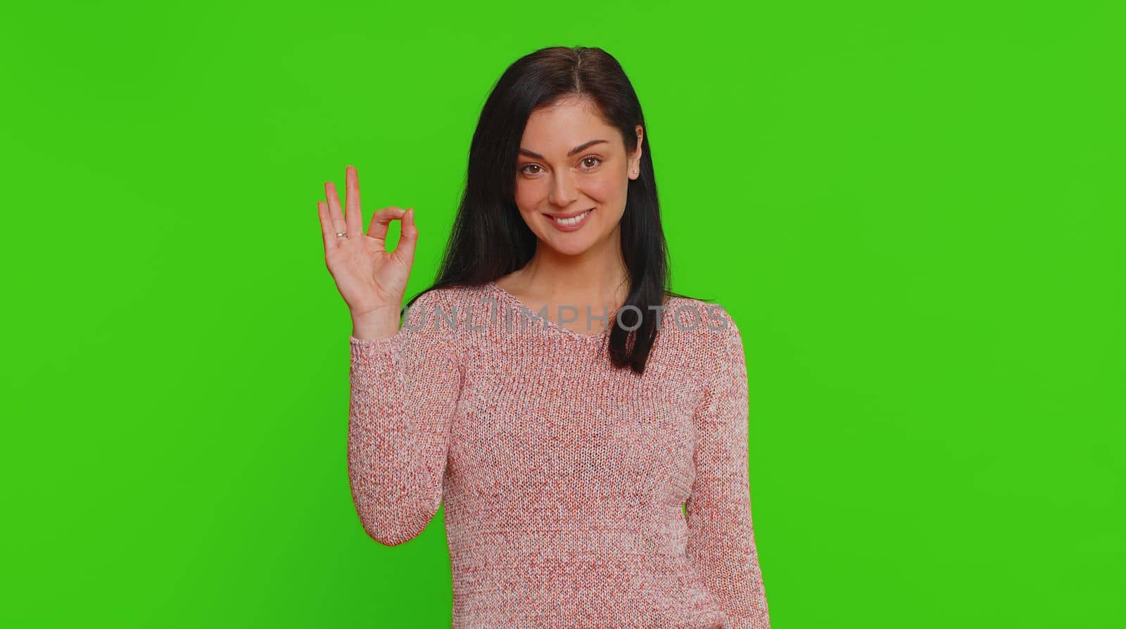 Ok. Joyful happy pretty woman looking approvingly at camera showing approve feedback gesture like sign positive something good. Young girl on green screen chroma key background. People sincere emotion