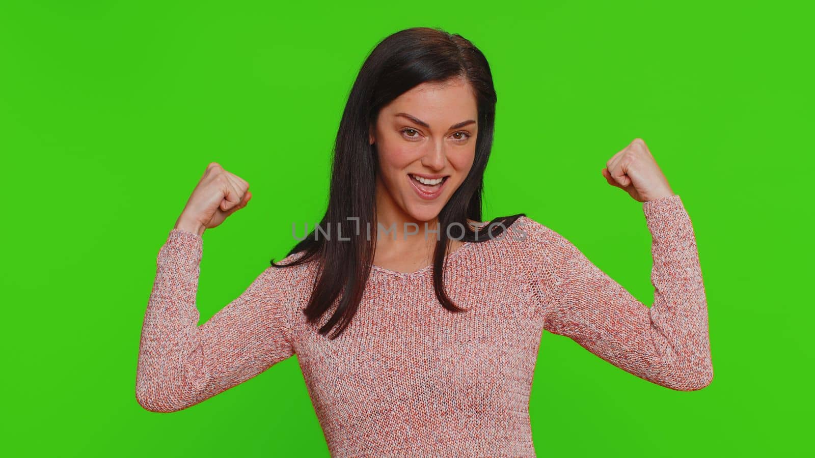 I am strong and independent. Proud success woman showing biceps and looking confident, feeling power strength to fight for rights energy to gain success win. Young adult girl on chroma key background