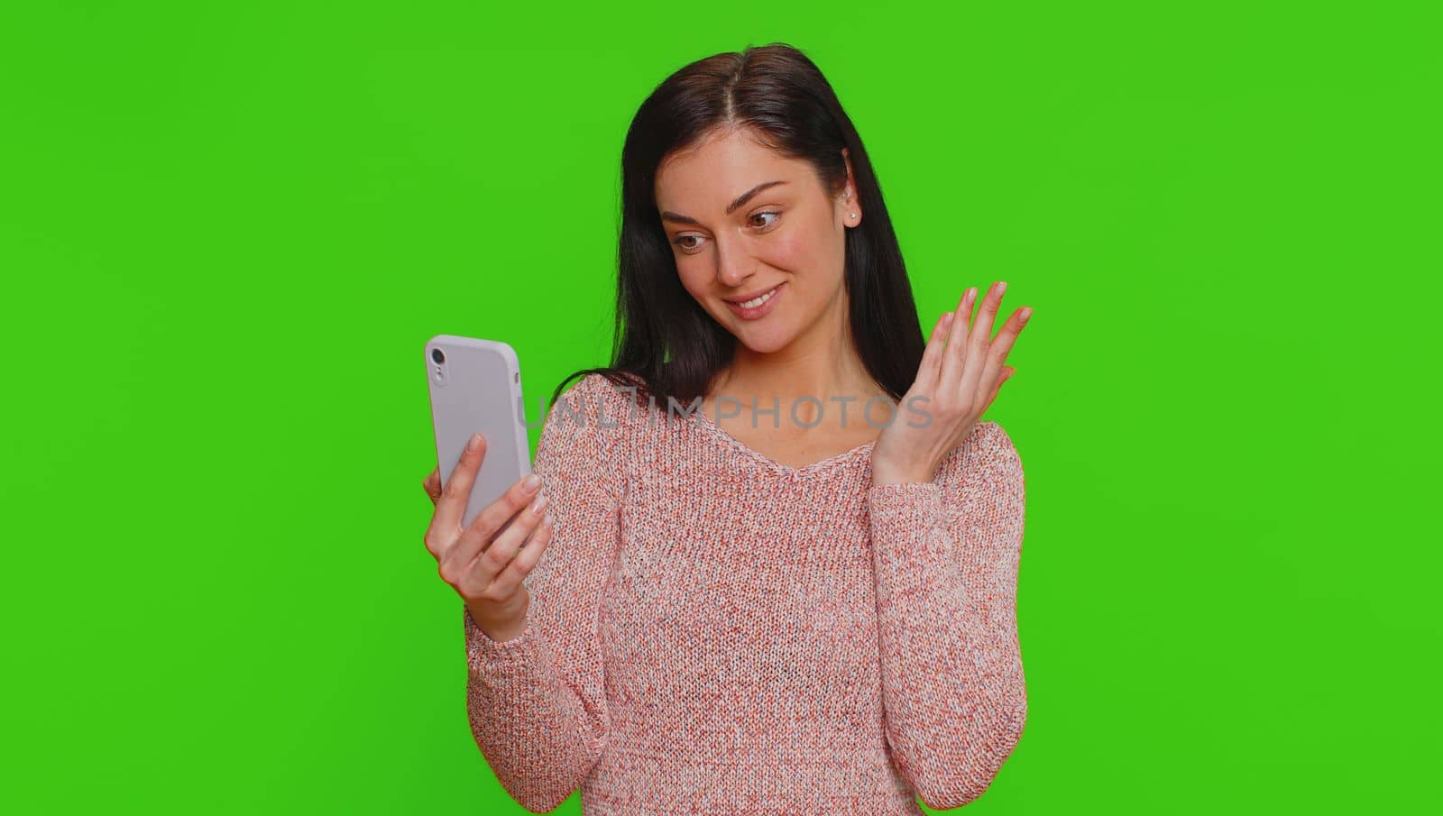 Pretty young woman influencer blogger taking selfie on smartphone, communicating video call online, recording new social media vlog story for subscribers. Girl isolated on chroma key background