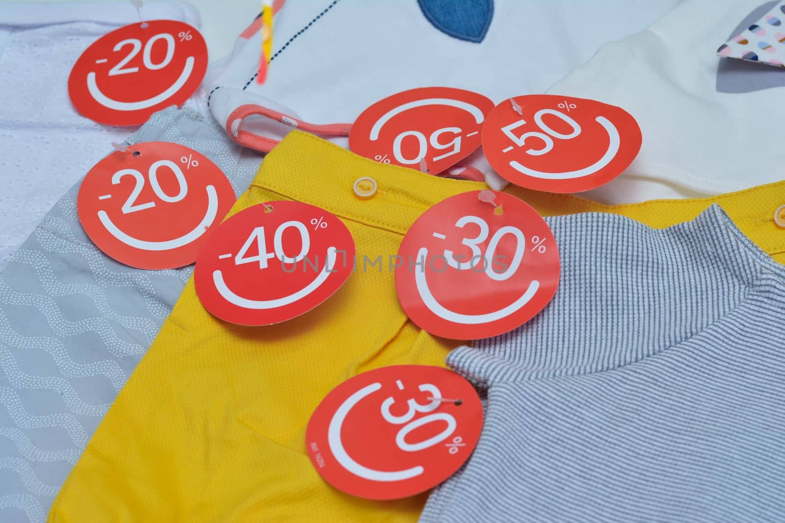 Clothes of shopaholic with discount labels Seasonal sale