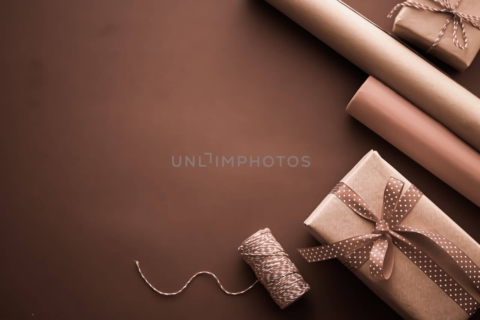 Gifts preparation, birthday and holidays gift giving, craft paper and ribbons for gift boxes on chocolate background as wrapping tools and decorations, diy presents as holiday flat lay design by Anneleven