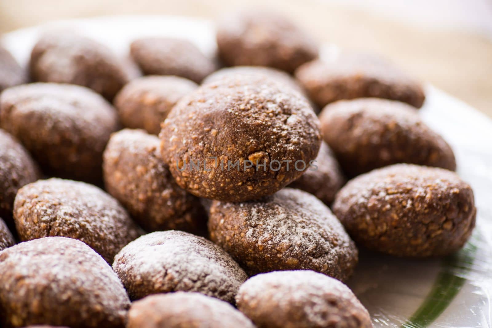 chocolate sweet cakes from mashed biscuits with additives, in a plate on a wooden table.