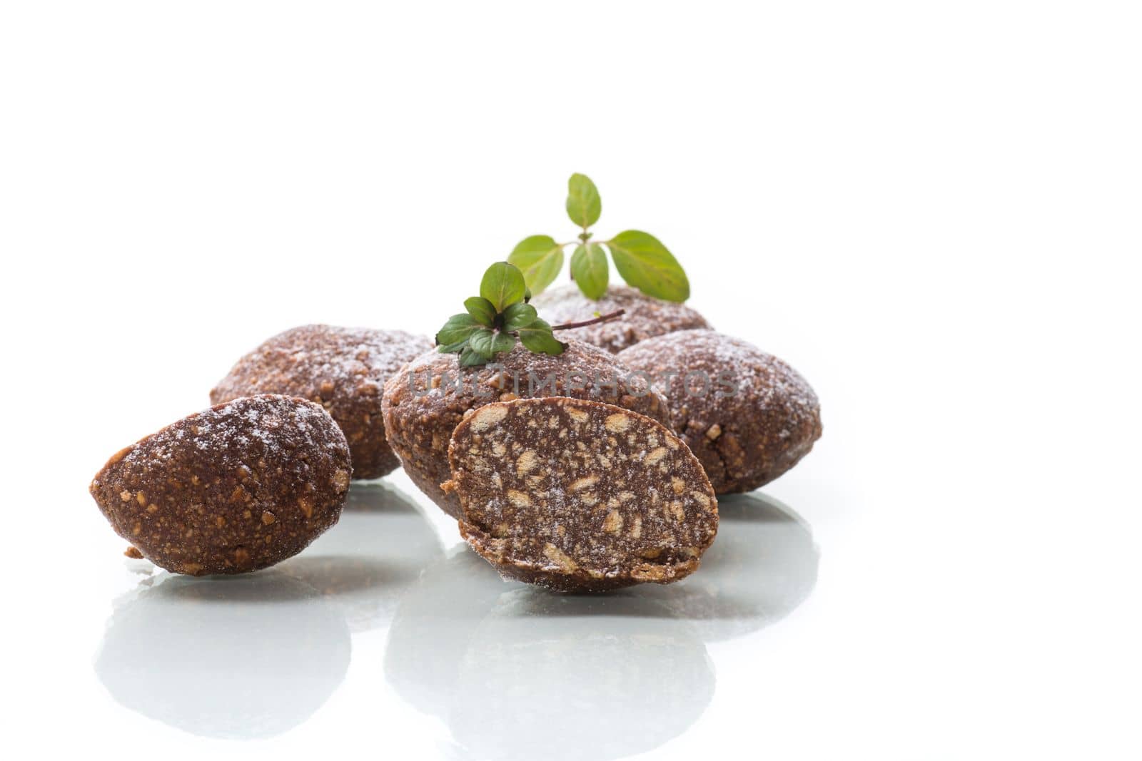 chocolate sweet cakes made from pureed biscuits with additives , isolated on white background .