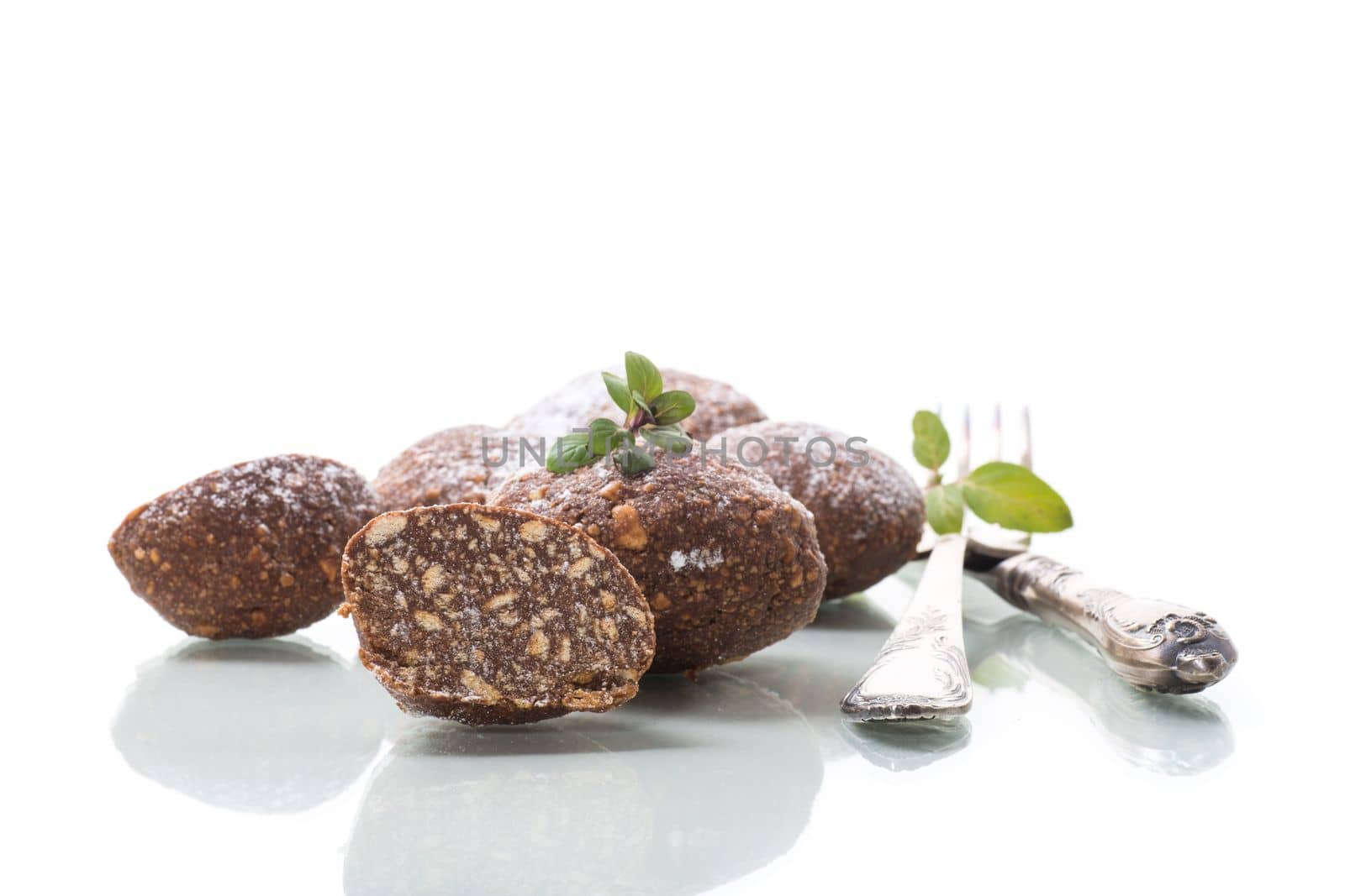 chocolate sweet cakes made from pureed biscuits with additives , isolated on white background .