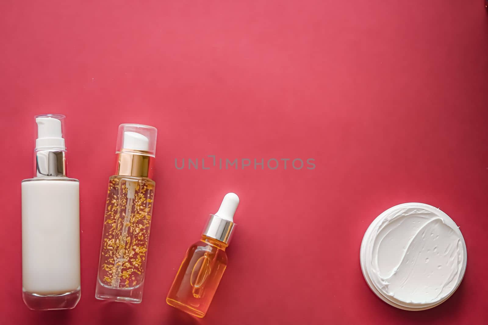 Skincare cosmetics and anti-aging beauty products, luxury skin care bottles, oil, serum and face cream on coral background by Anneleven