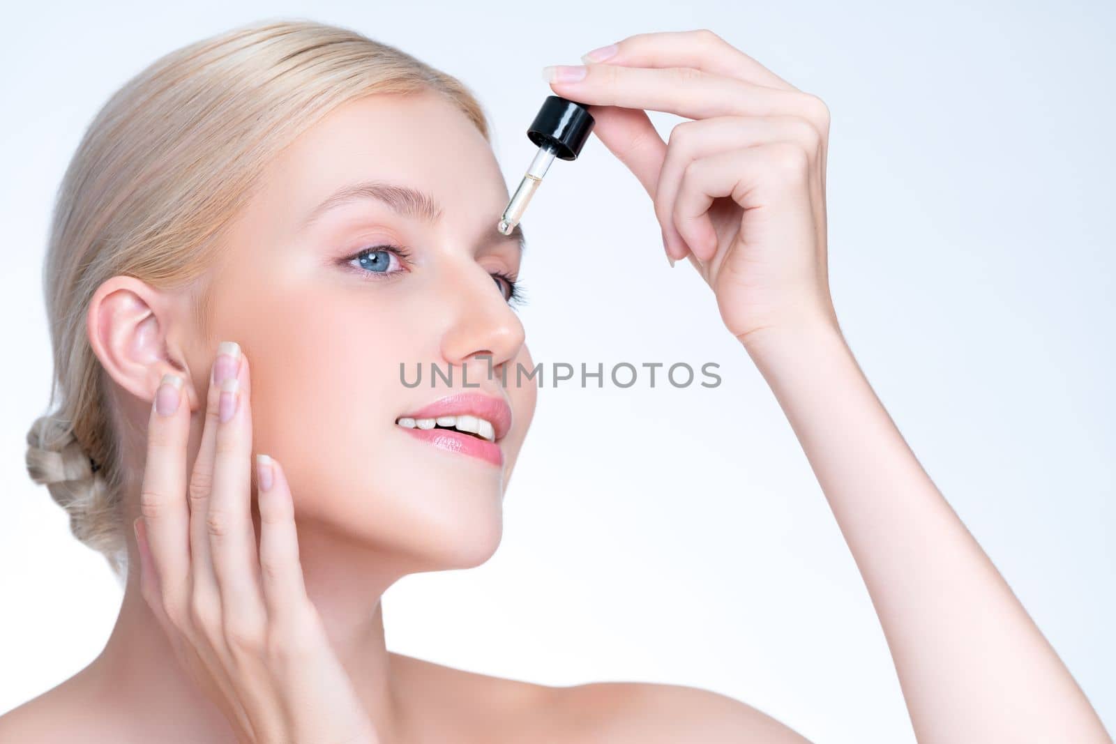 Closeup personable portrait of beautiful woman applying essential oil bottle for skincare product. Cannabis extracted CBD oil dropper for treatment and cannabinoids concept in isolated background.