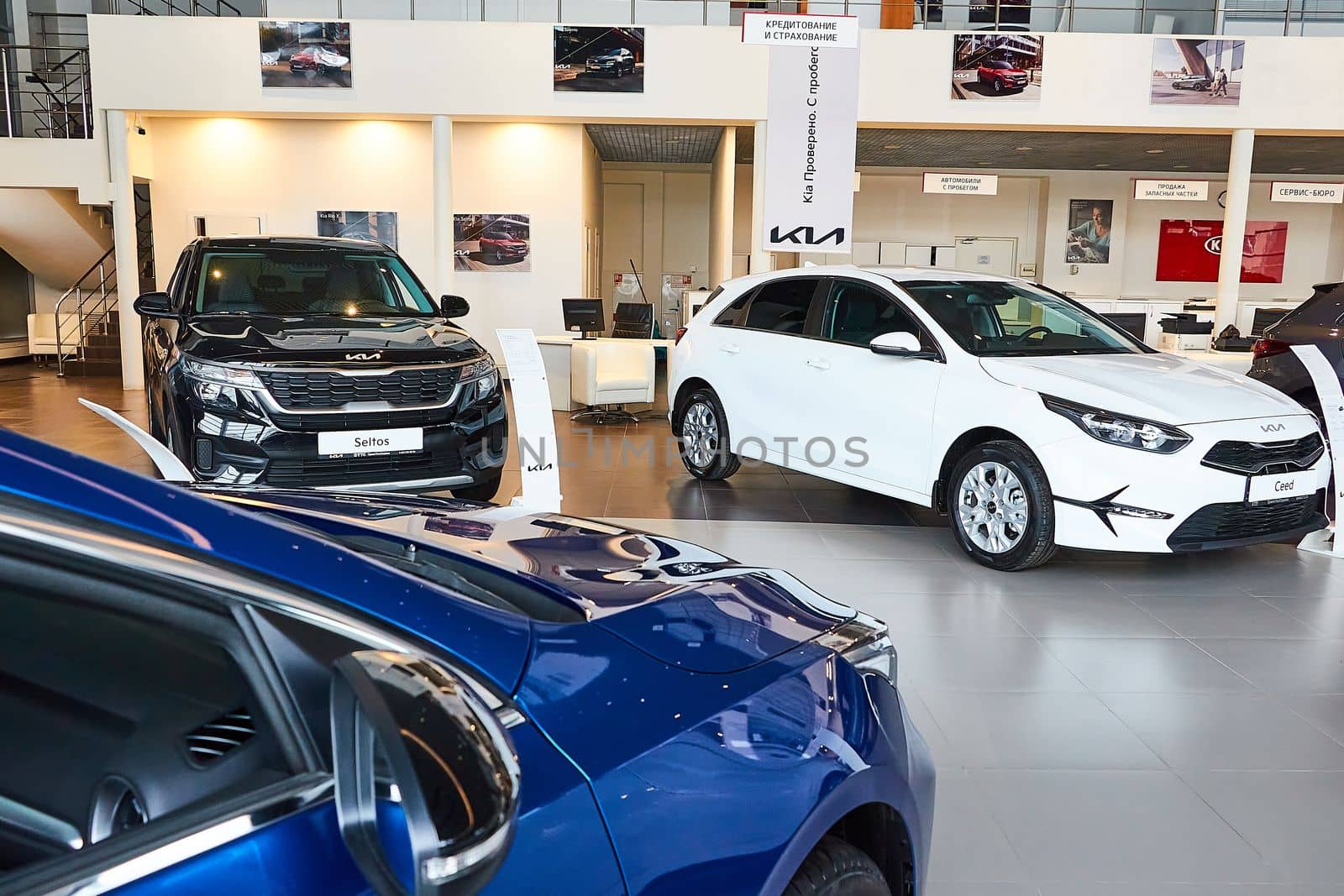 Kazan, Russia - November 25, 2022: Cars in showroom of dealership Kia in Kazan in country Russia. Partial focus by keleny