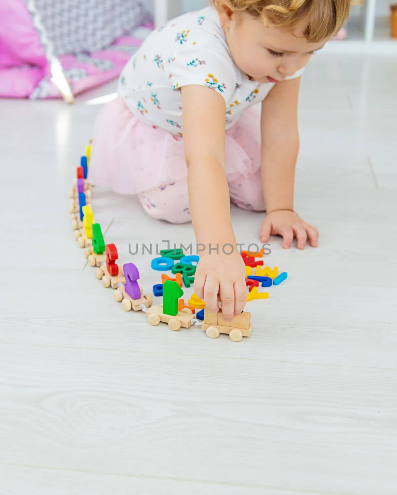 A child plays with a train made of numbers. Selective focus. Kid.