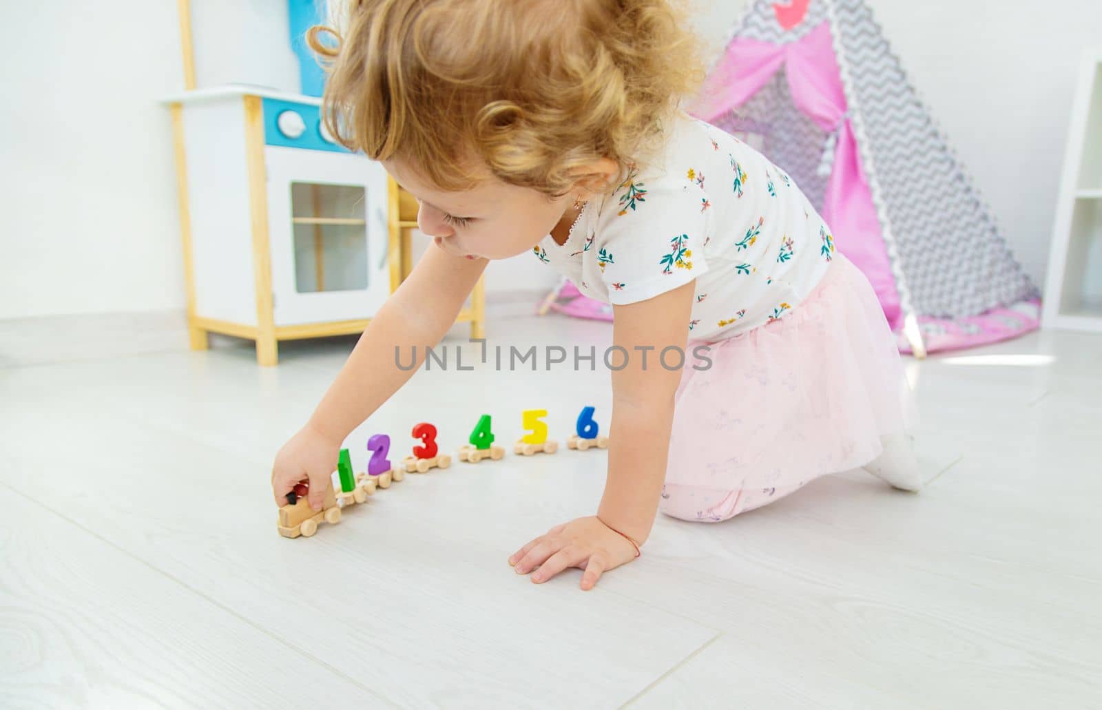 A child plays with a train made of numbers. Selective focus. Kid.